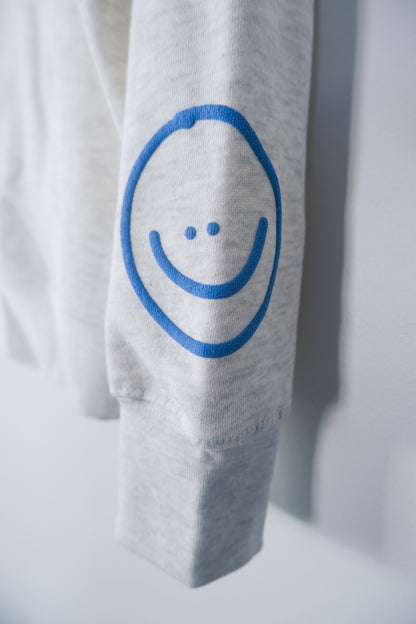 WHO CARES SMILEY CREWNECK